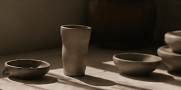 Handmade ceramics resting on a sunlit studio table