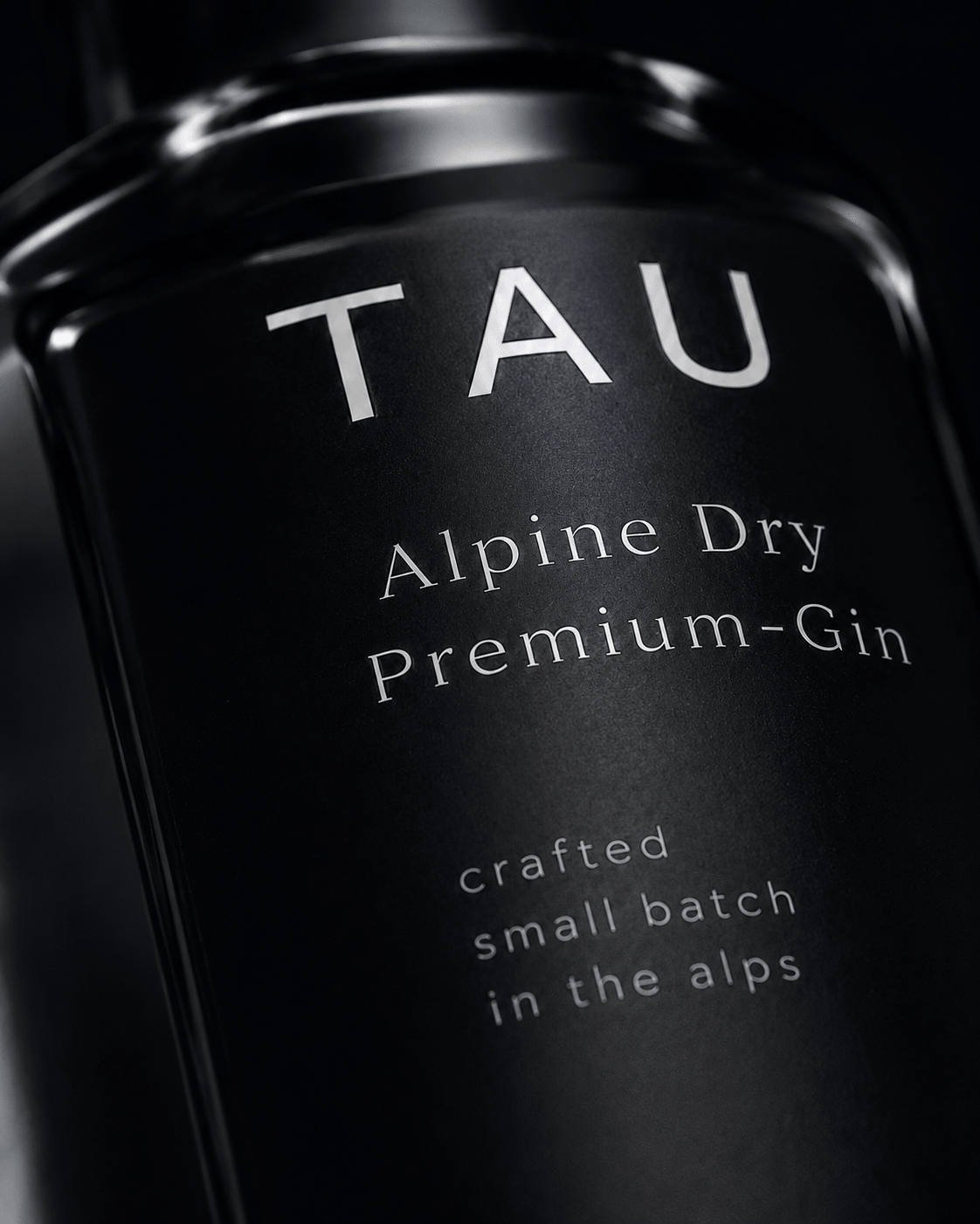 Macro close-up of the TAU bottle label